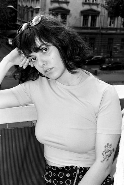 Trans woman with layered haircut and curtain bangs that frame the face beautifully, offering an alternative to forehead reduction surgery and helping you spend less time doing your hair by utilizing a hair style app
