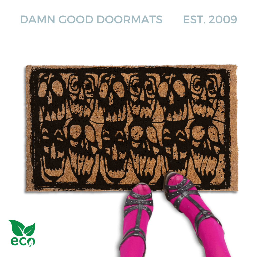 Gen X Halloween doormat with skulls stencil from 1985 cult film Desperately Seeking Susan on an outdoor doormat. Pictured with a womans feet in studded heels and pink tights