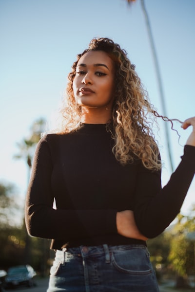 Tawny medium brown curly haired woman