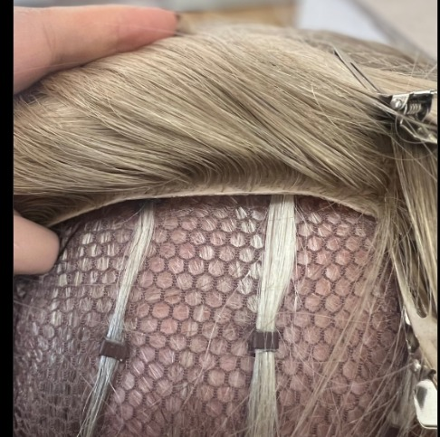 A hair topper getting installed