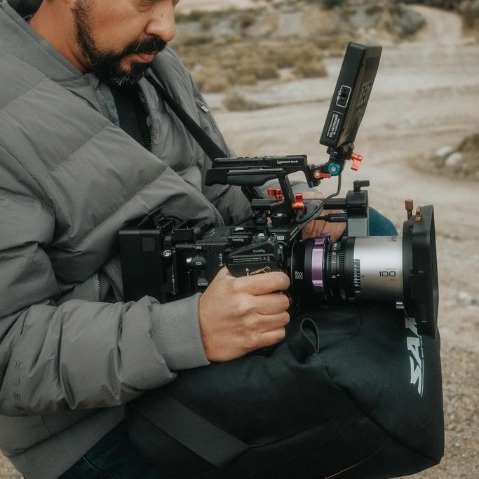 man shooting with saddle