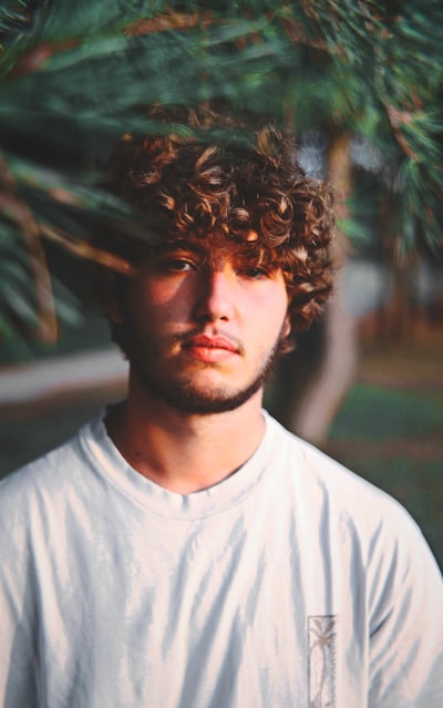 a man with a curly perm