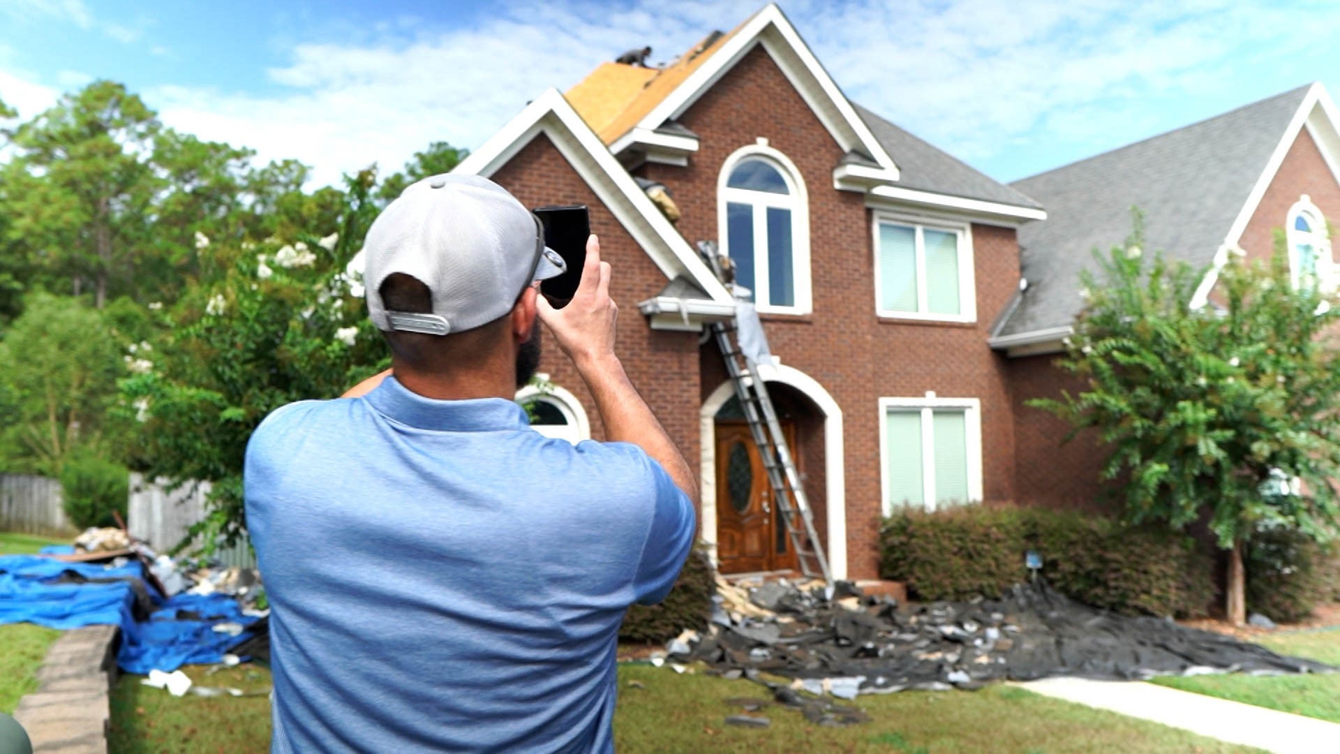 Roofers inspecting home roof