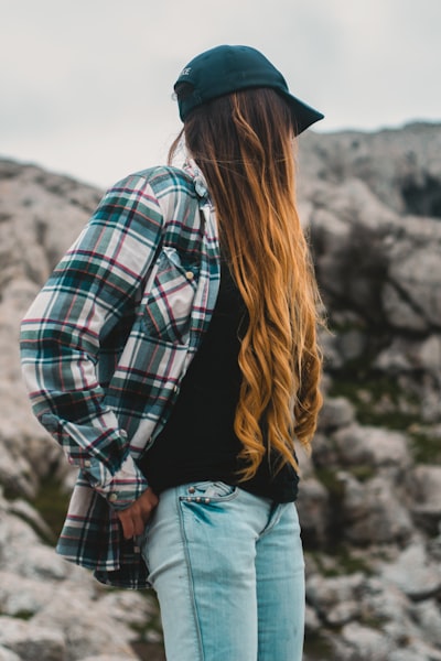 a woman wearing a cap with her wig