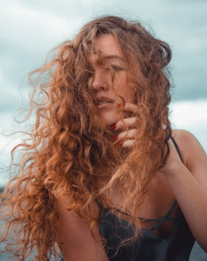 curly rezo haircut on copper colored hair
