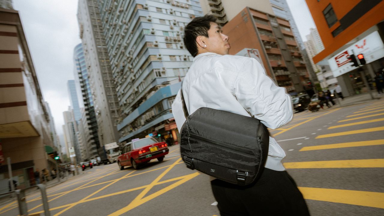 Traveler wearing Sakk Xplorer Sling while exploring a city