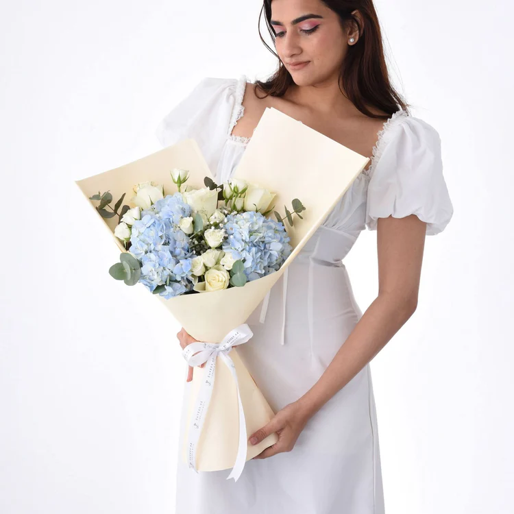 Girl holding blue roses bouquet