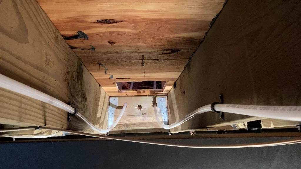 New water lines passage from under floor into stud wall