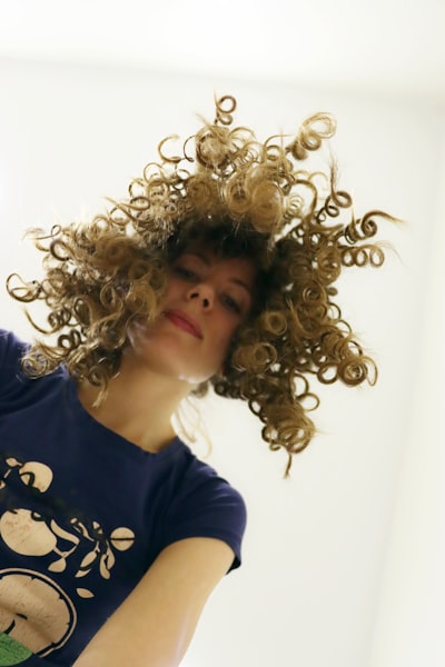 a woman with a natural curly permn