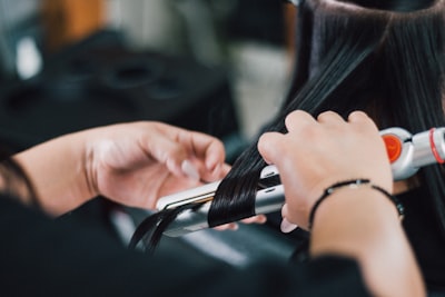 a hairstylist flat ironing hair