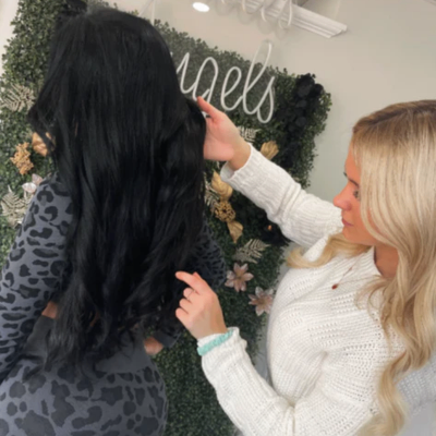 Professional fixing up hair of client