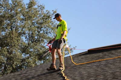 a roofer cleaning a newleny instaled roof in mobile alabama