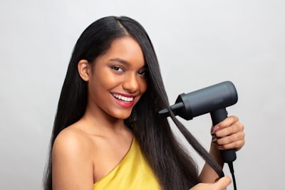 a girl styling hair extensions