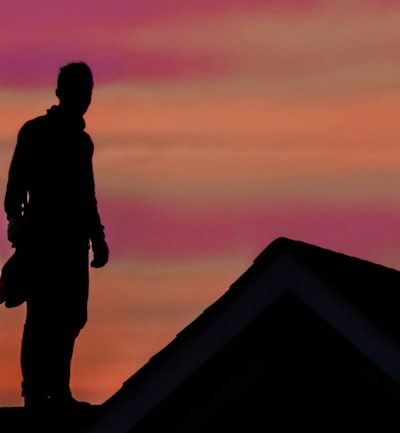 a roofer standing on a durable roof