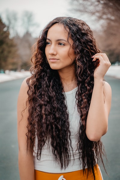 a young woman wearing curly hair extensions